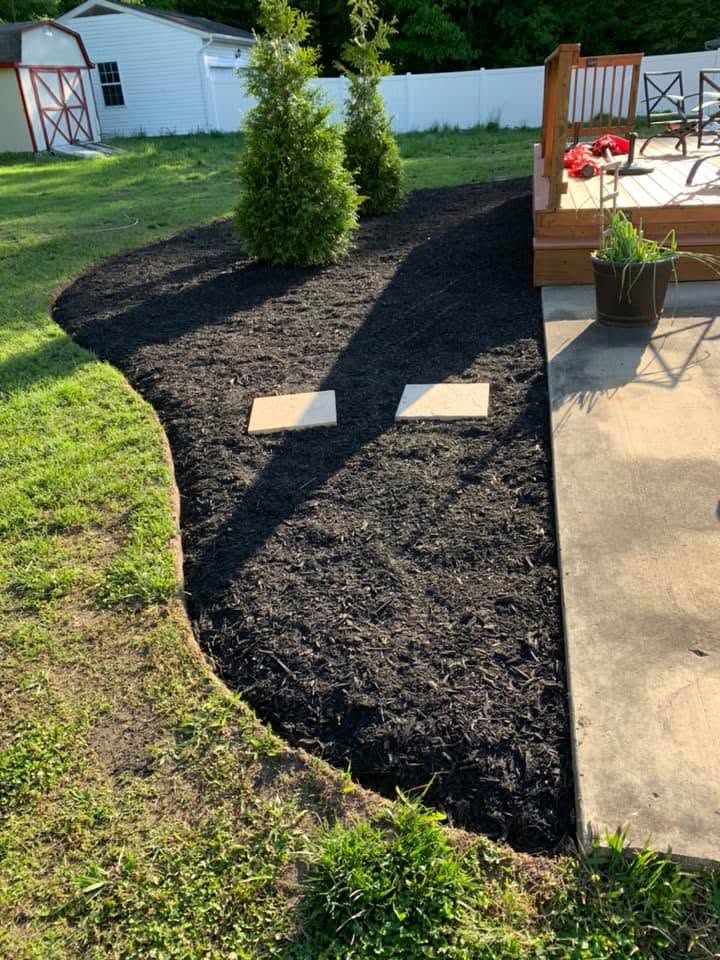 Freshly mulched garden bed with stepping stones and a clean lawn edge